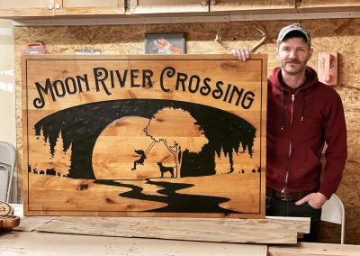 girl swinging moon river sign